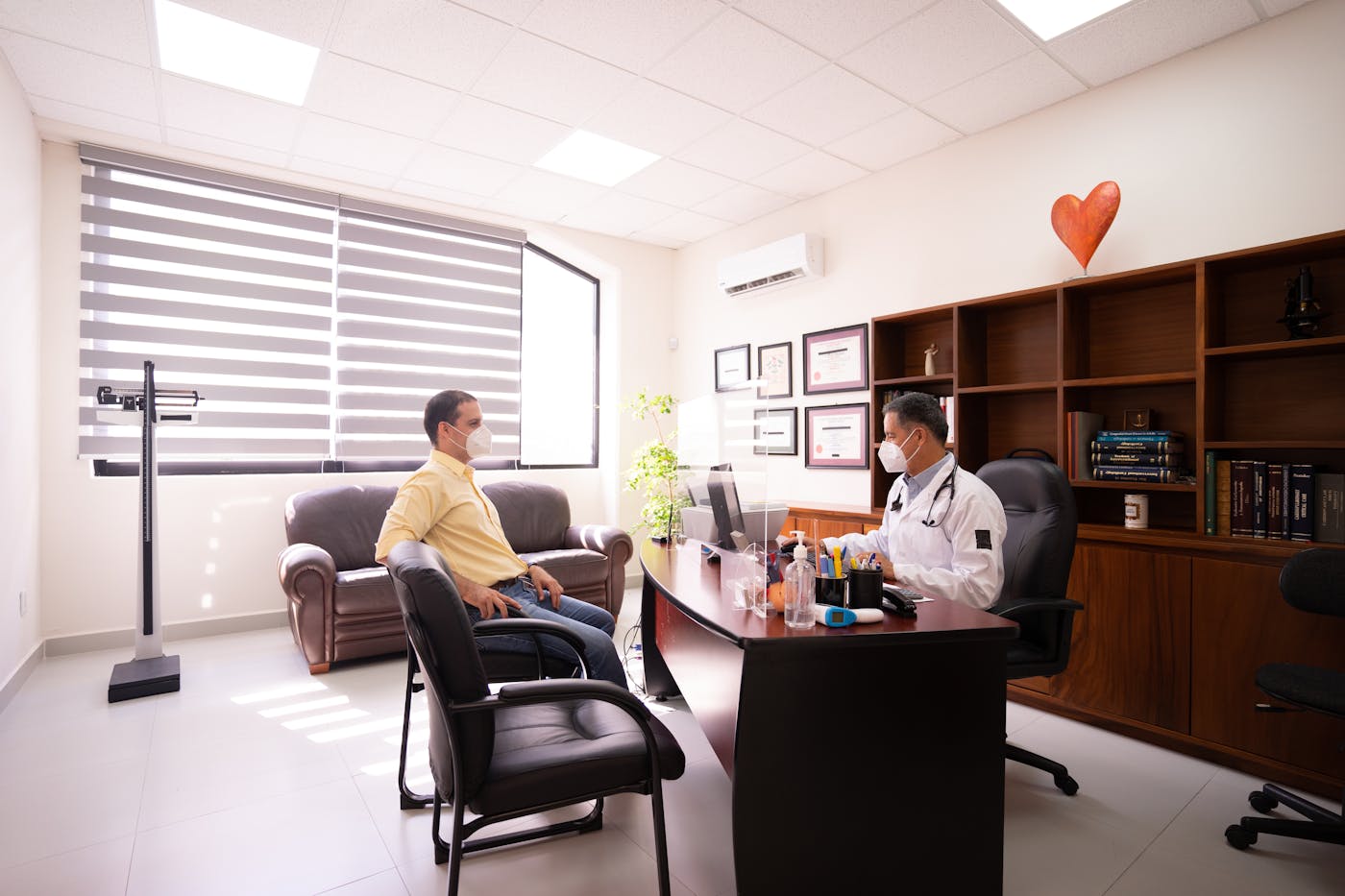 Doctor greeting a patient inside a bright clinic