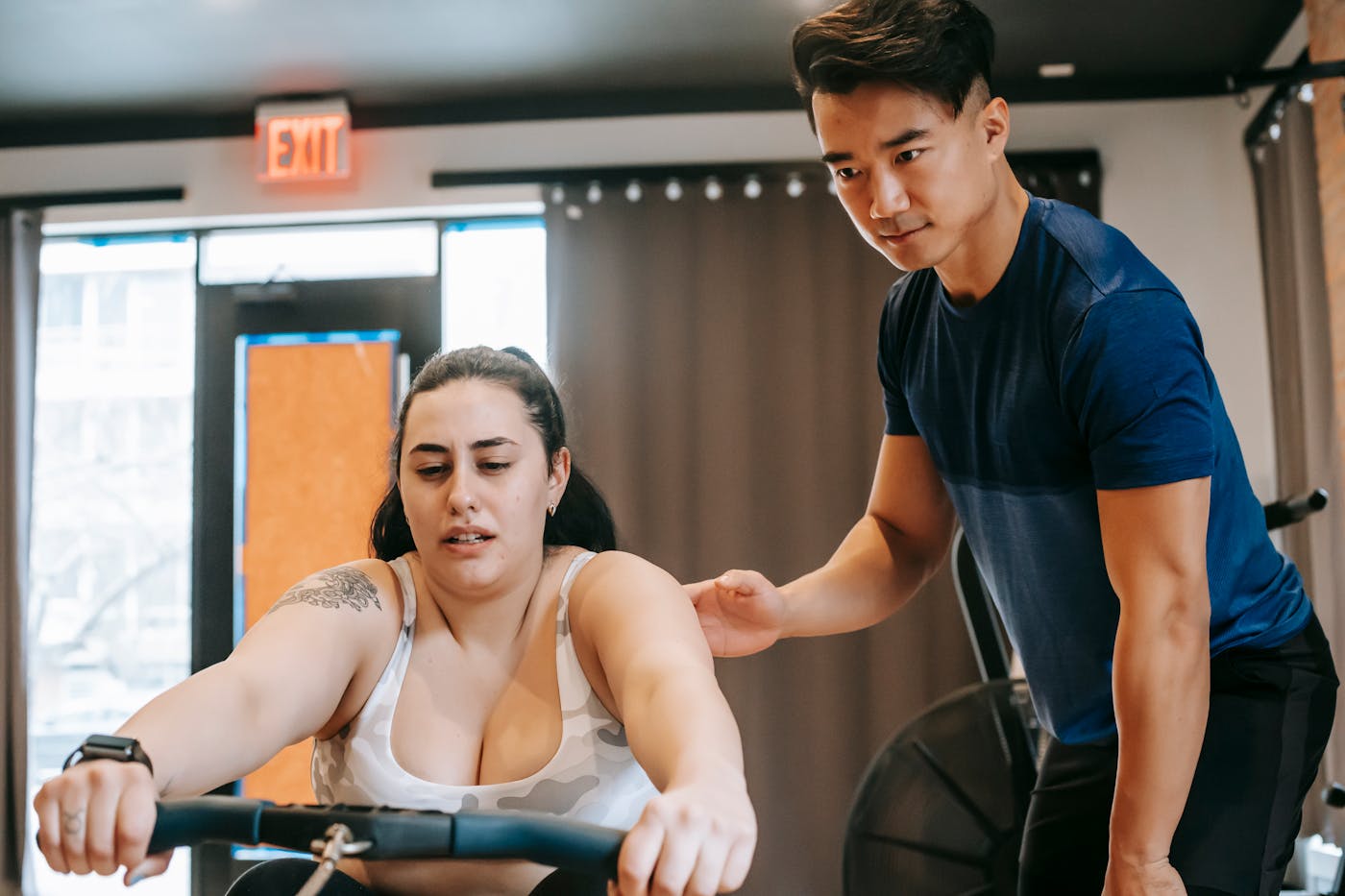 Trainer coaching movement on a functional training floor